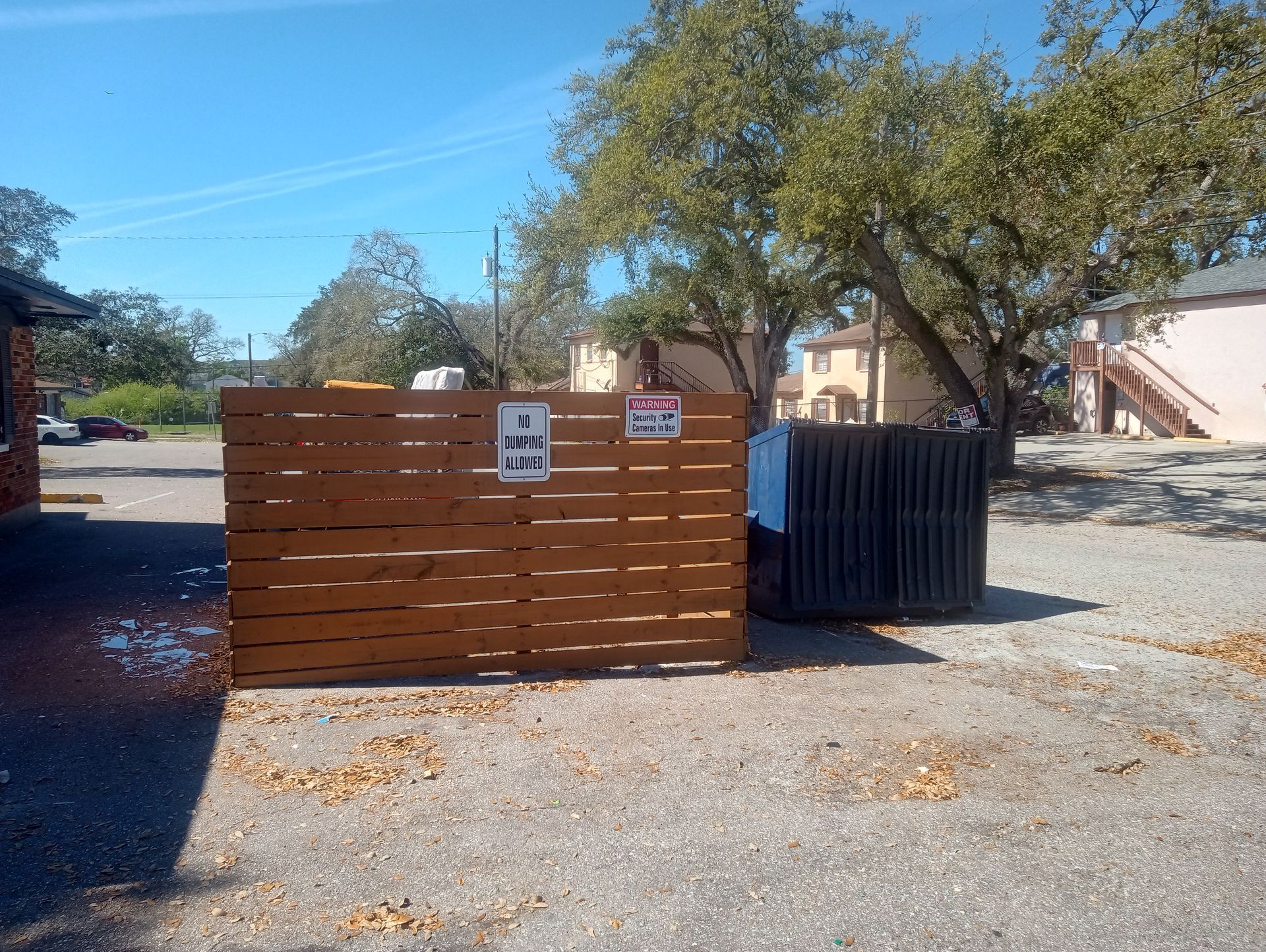 A wooden fence with a sign on it that says no dogs