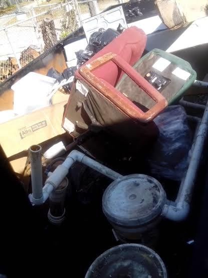 A pile of garbage is sitting on top of a table.