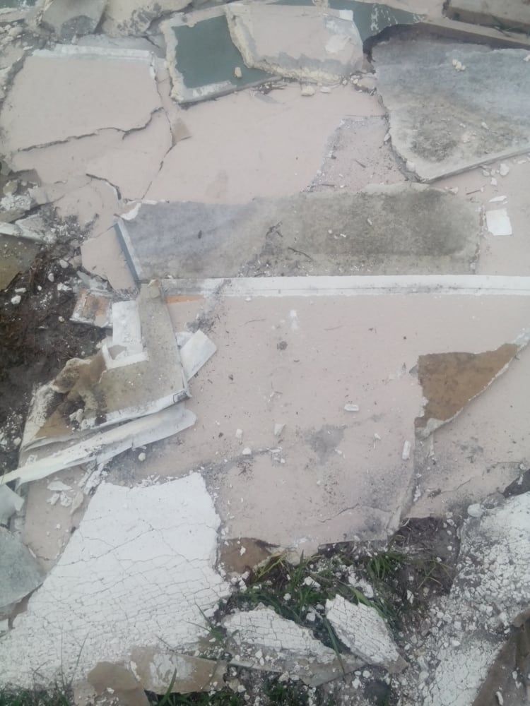 There are a lot of pieces of concrete on the ground.